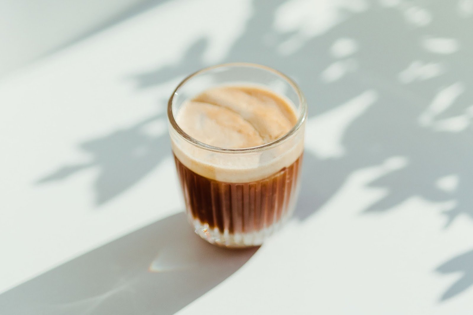 a latte in a glass cup